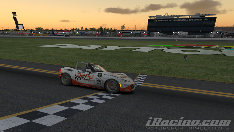 The Team Oppo Miata passes under the checkered flag as the sun begins to set and 2.4 hours passed since the green.